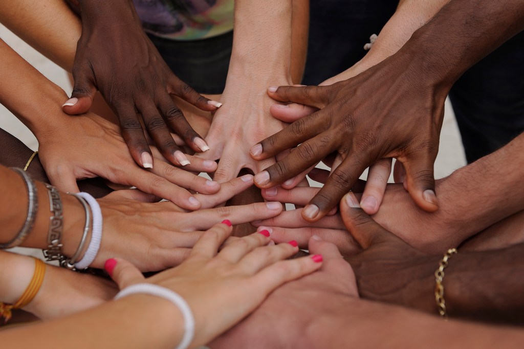 Many hands coming together